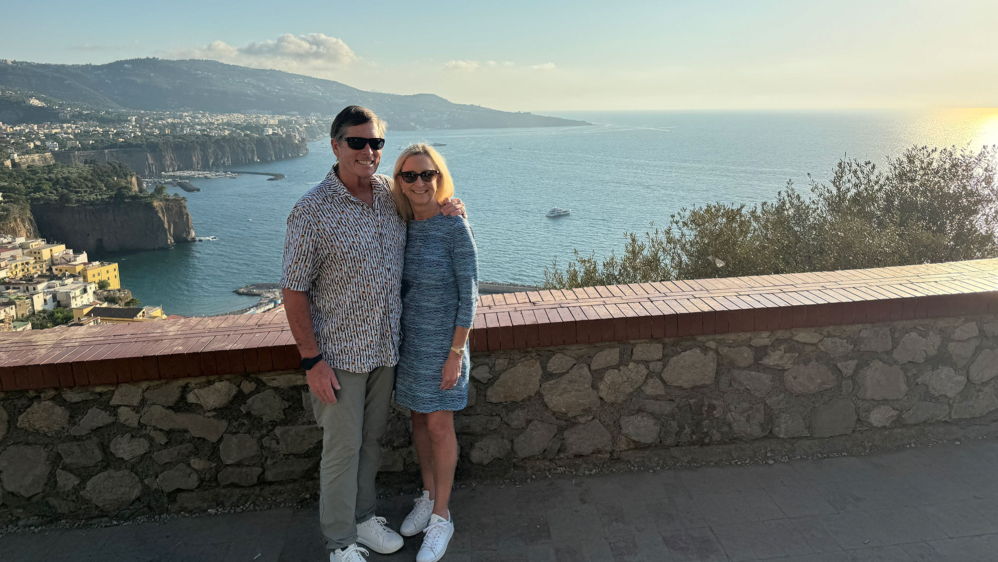 Man and woman posing by the ocean.