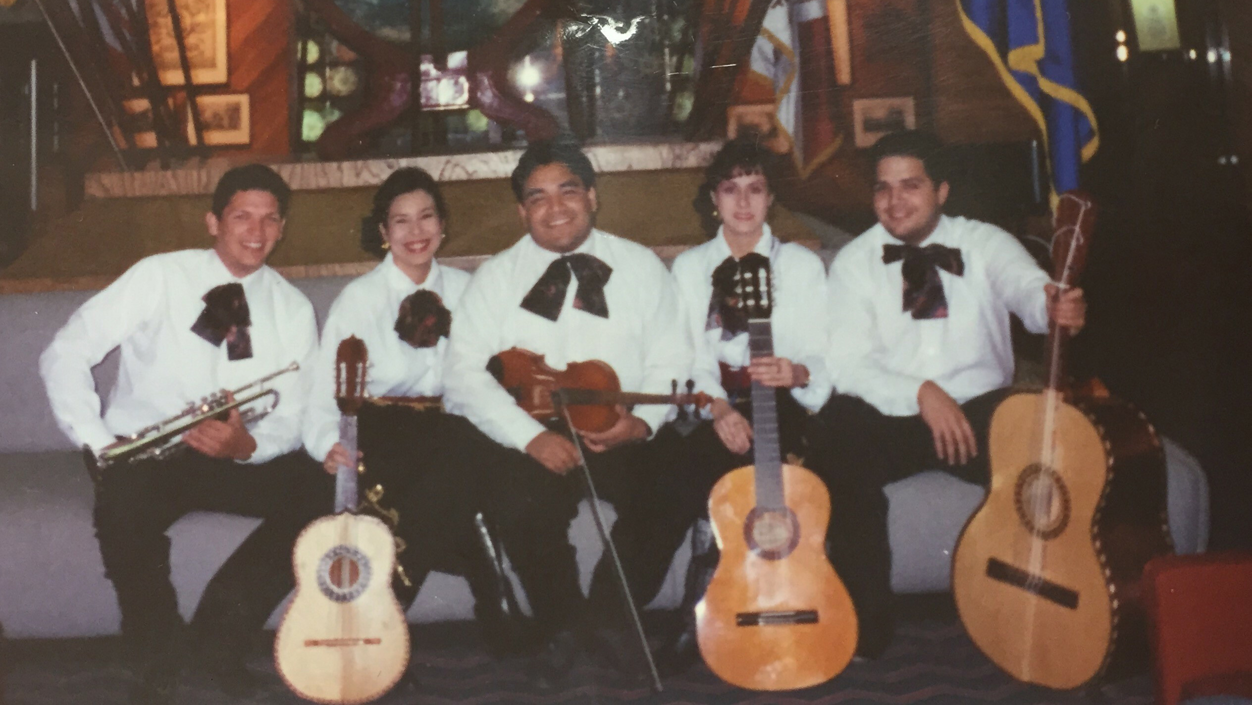 Five people in a mariachi band. 