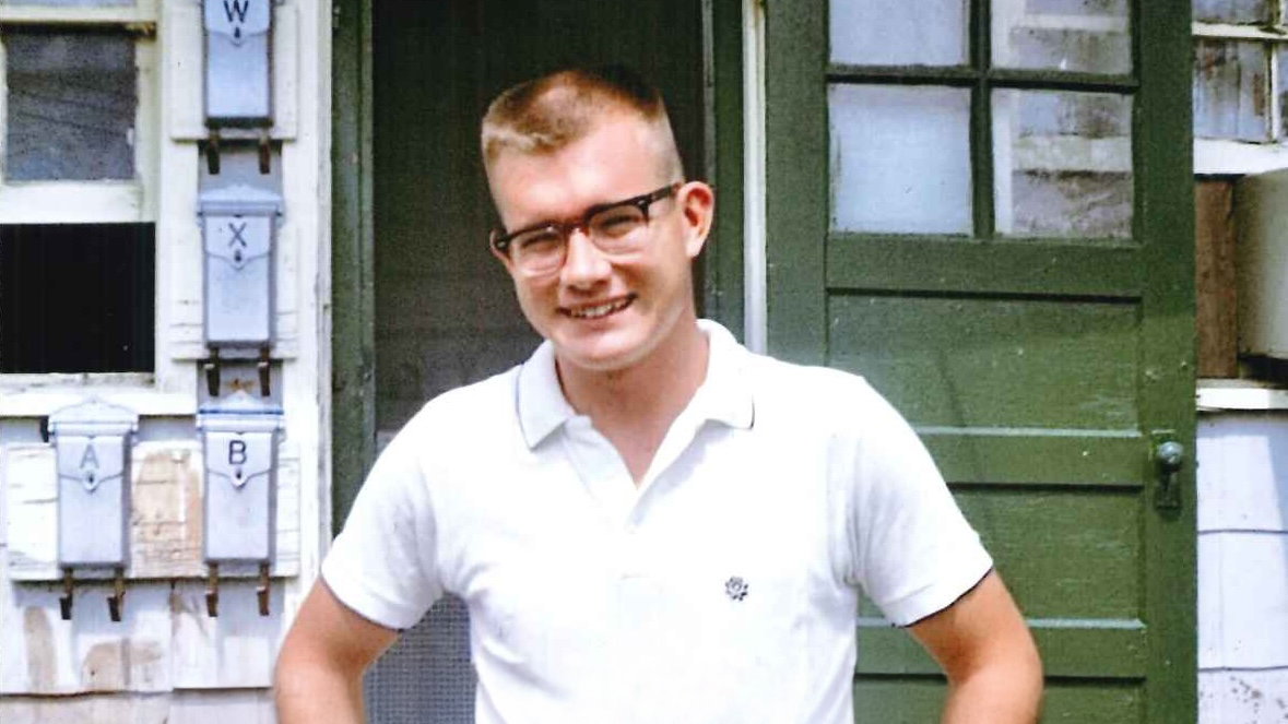 Man standing in front of doorway.