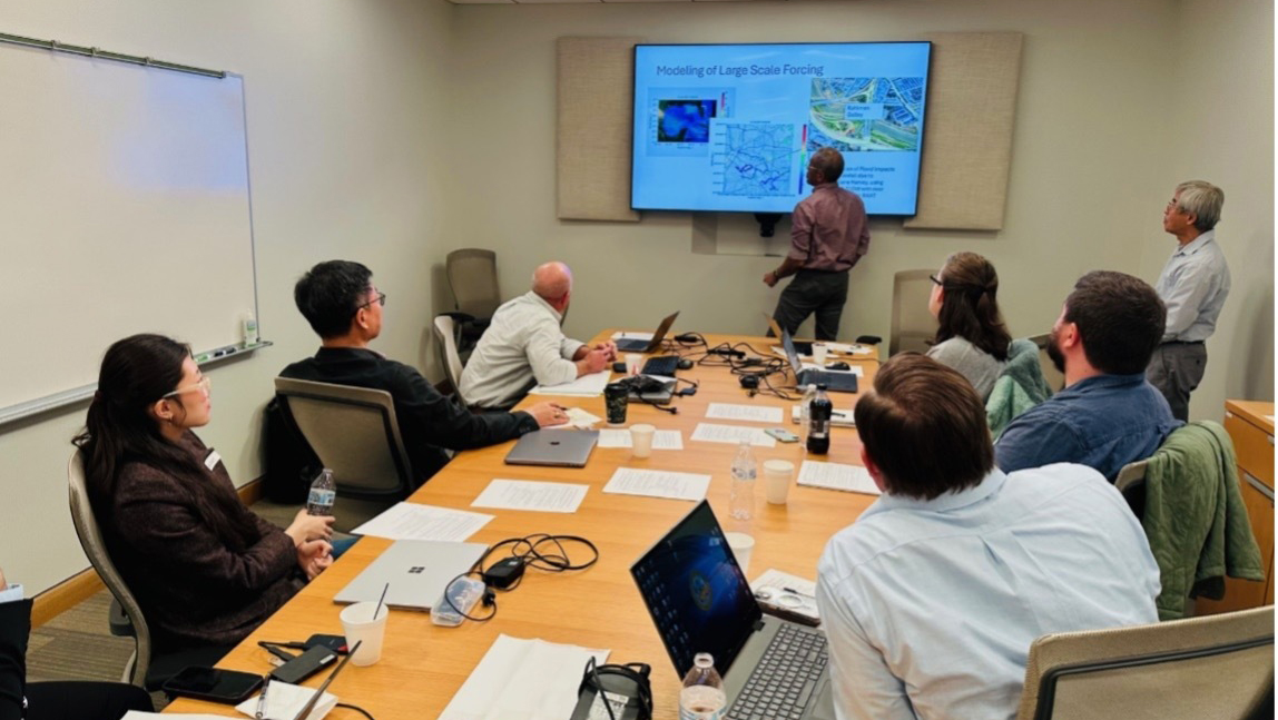 A group of people in a conference room attending a presentation.