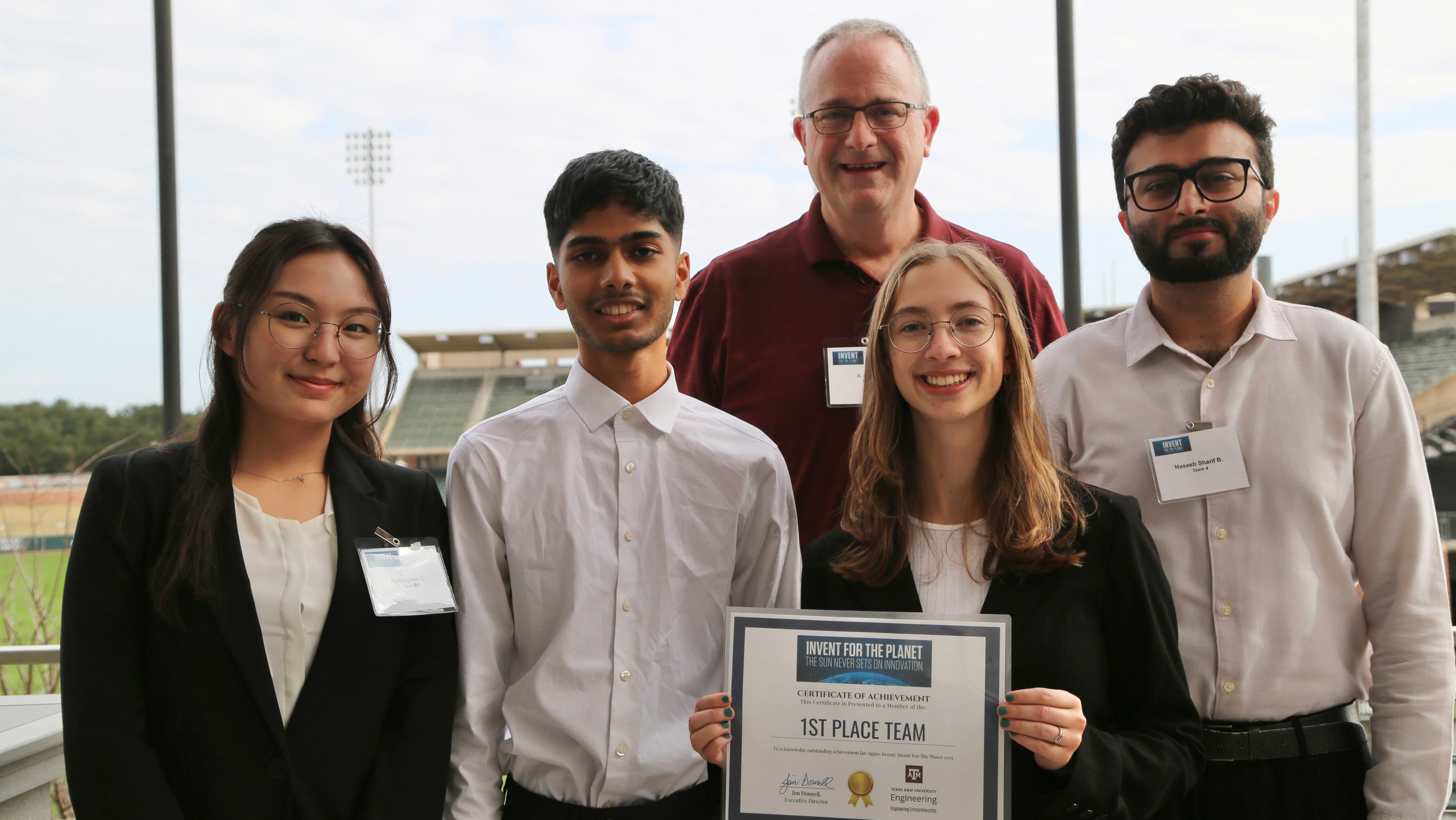 A group of five people holding a certificate.