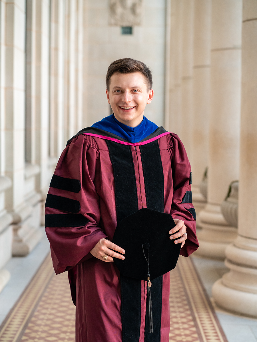 A graduate posing for a photo.