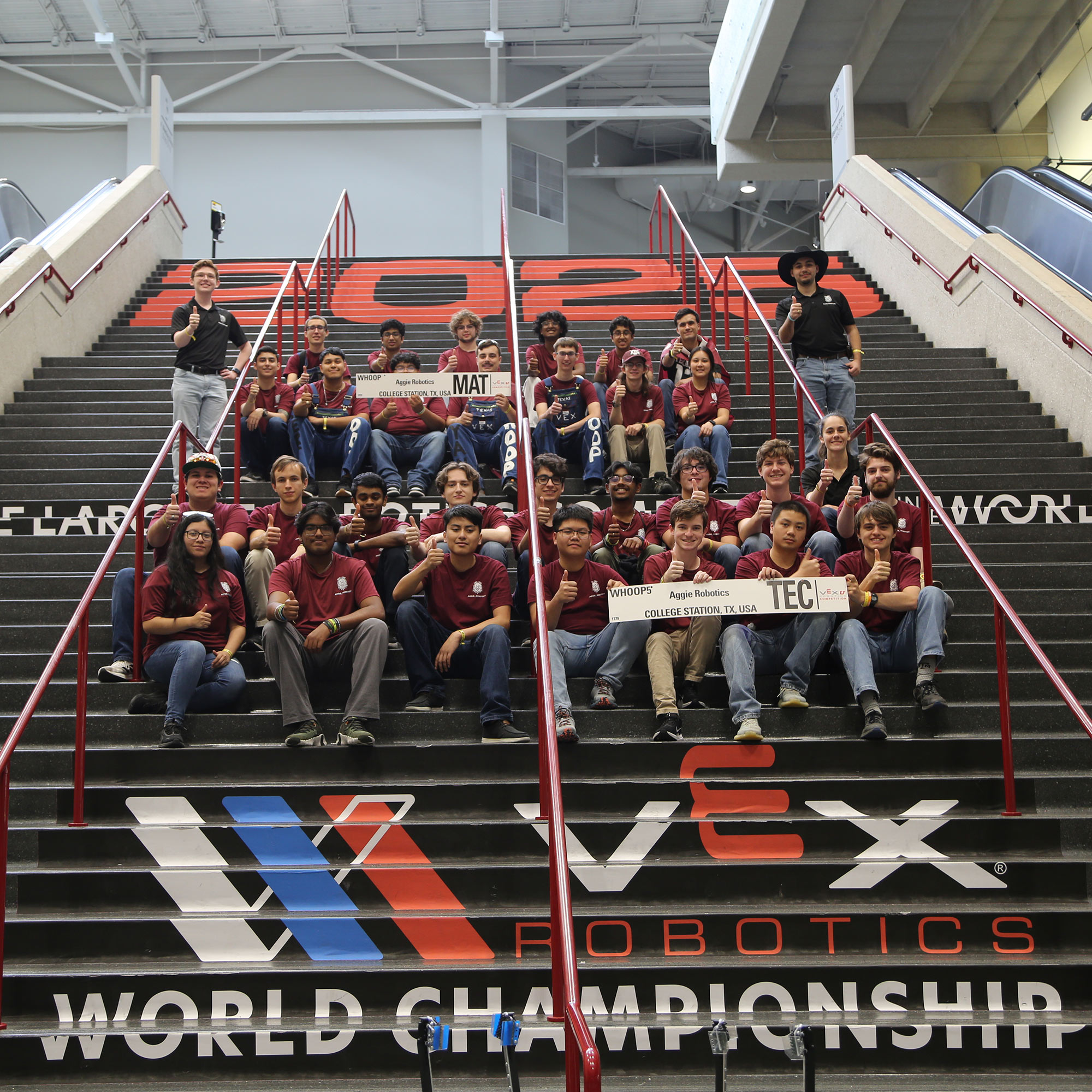 A group of people sitting on stairs.