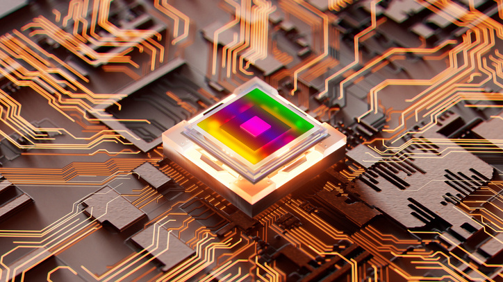 Glowing futuristic semiconductor chip on a circuit board.