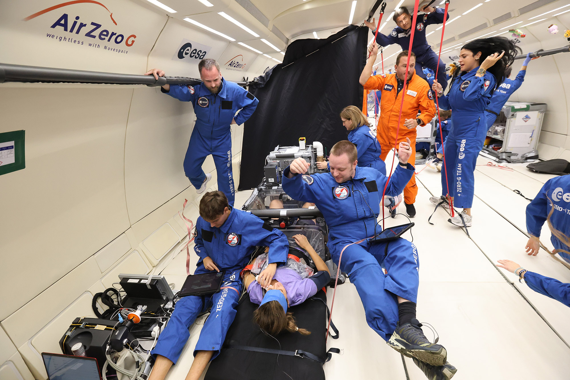 Researchers floating while performing experiments.
