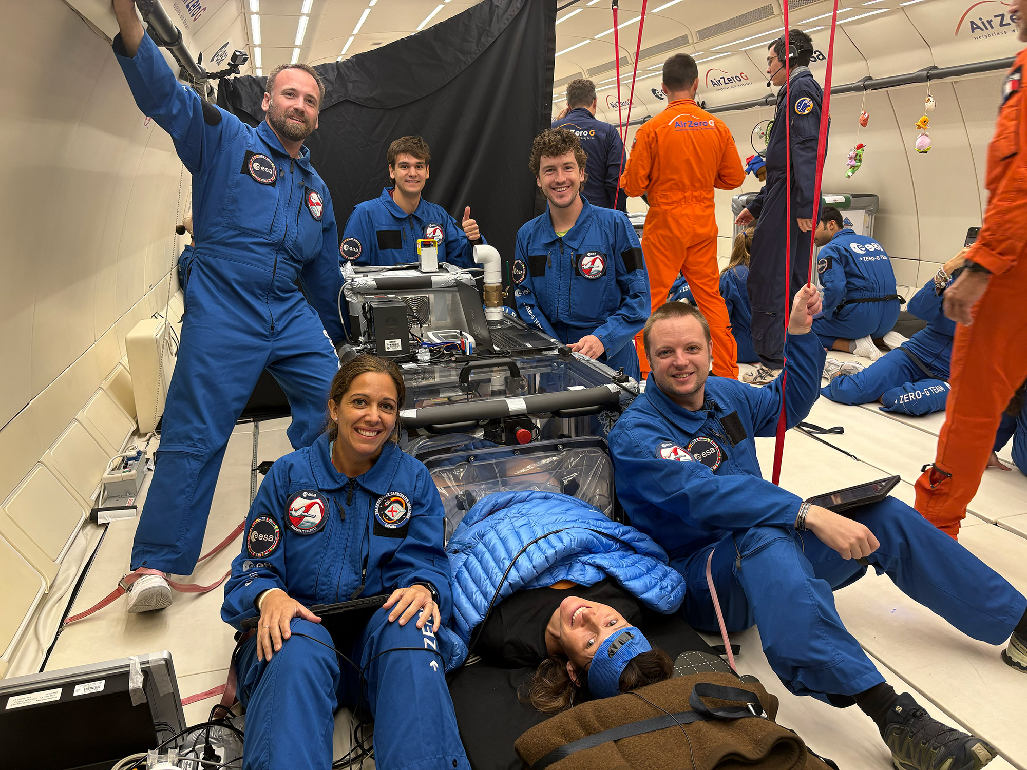 Researchers pose with the lower body negative pressure chamber.