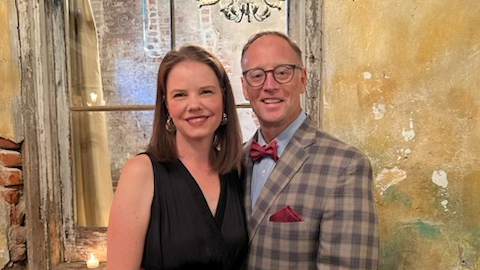 Man and woman stand for photo.