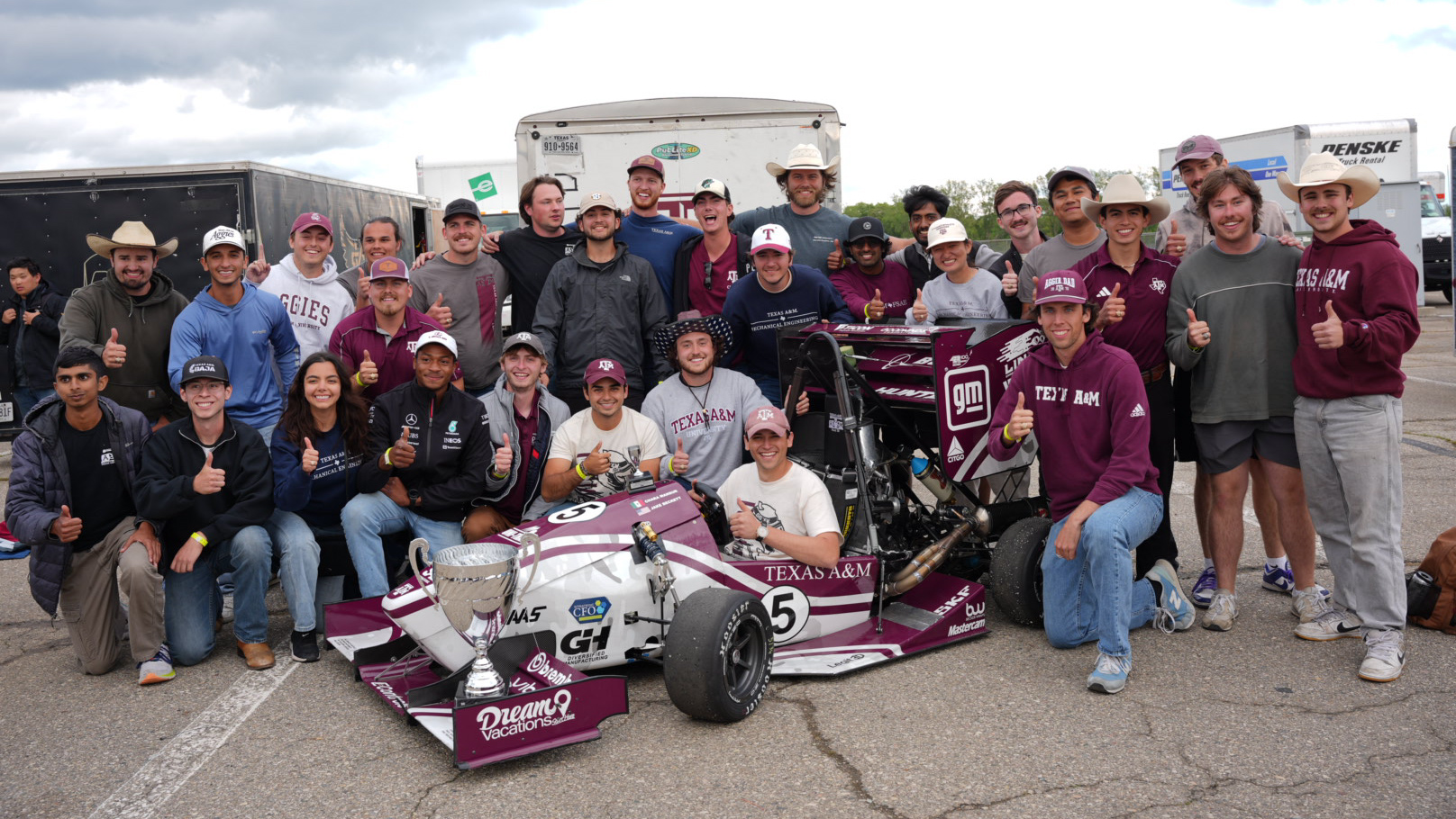 A group of students with a race car.