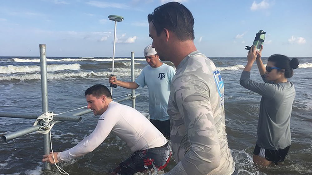 Dr. Figlus and his undergraduate students place their instruments in the water off of the Galveston coast to conduct testing and measurements for a project.