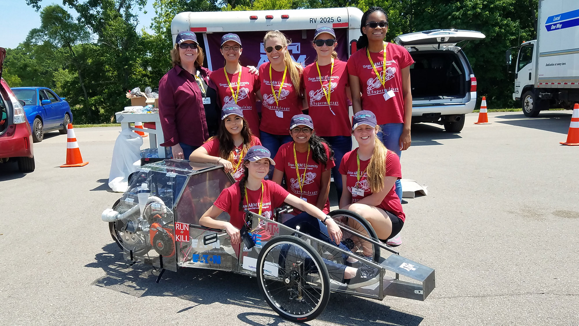 Women in Engineering Supermileage vehicle student team with vehicle. 