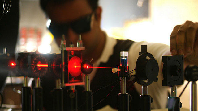 Student in lab adjusting laser