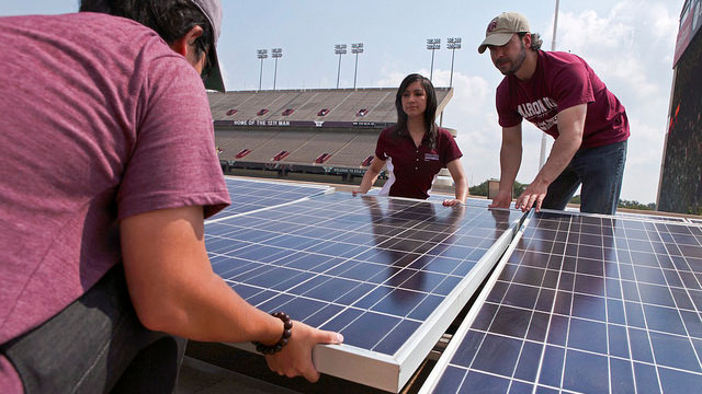 Student setting solar panel down