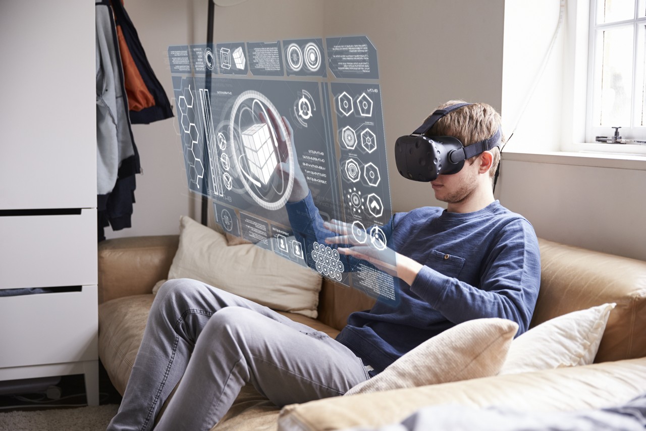 A young student wearing AI virtual headset on a couch.