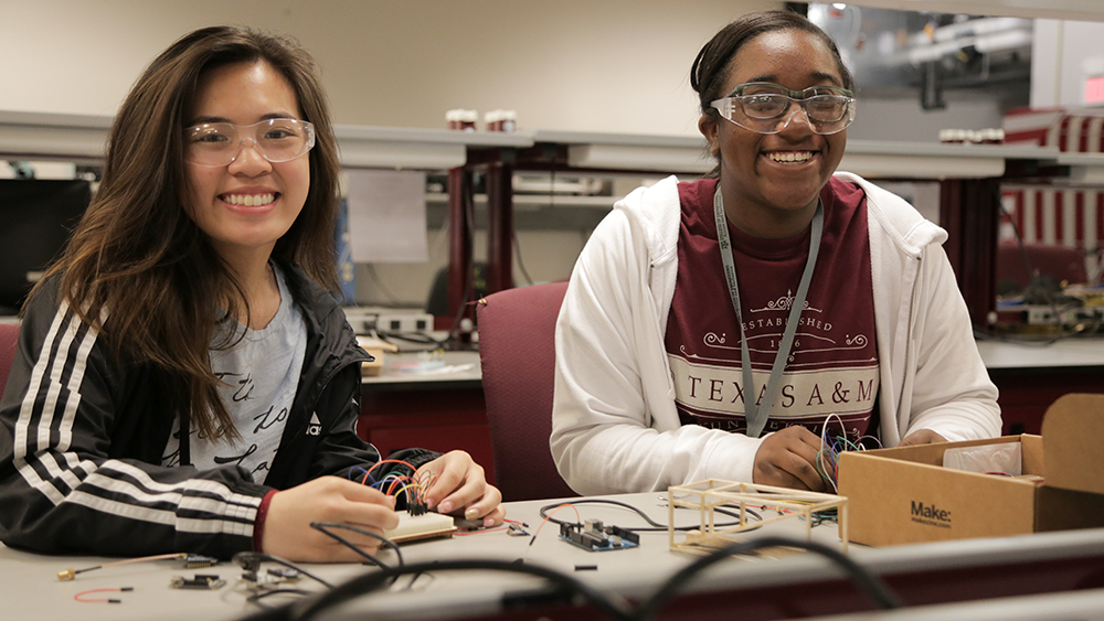 Two female students work on engineering project