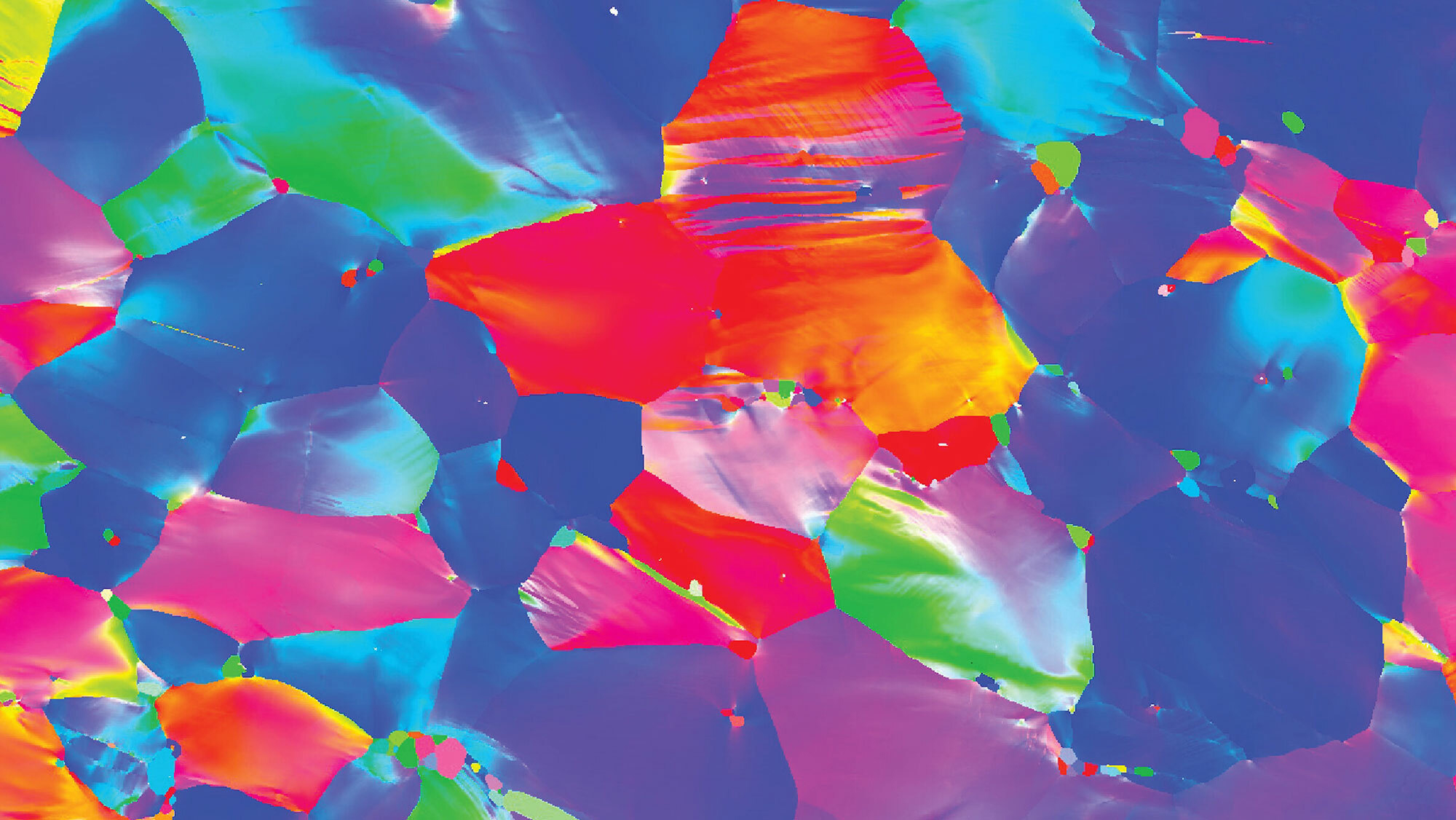 A field of pink, purple, cyan, indigo, orange and yellow shapes packed together, resembling vibrant abstract art.